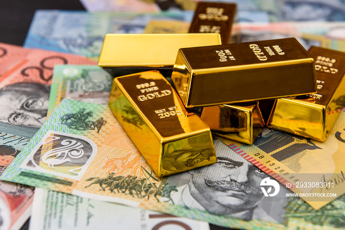 Australian dollars with gold ingots close up