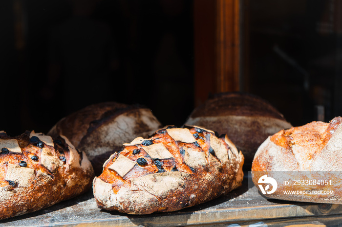 Freshly baked unleavened bread on a store shelf. Fresh gluten-free bread on a wooden stand. Useful bread with bran.