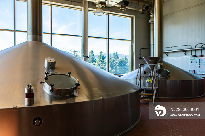 Mash lauter tun, two stainless steel big vessels, Brewing tank top with glass manway door, Modern brewhouse, brewery room in big beer factory machines