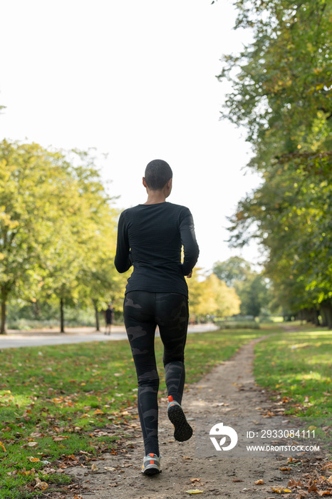 Rear view of woman jogging in park