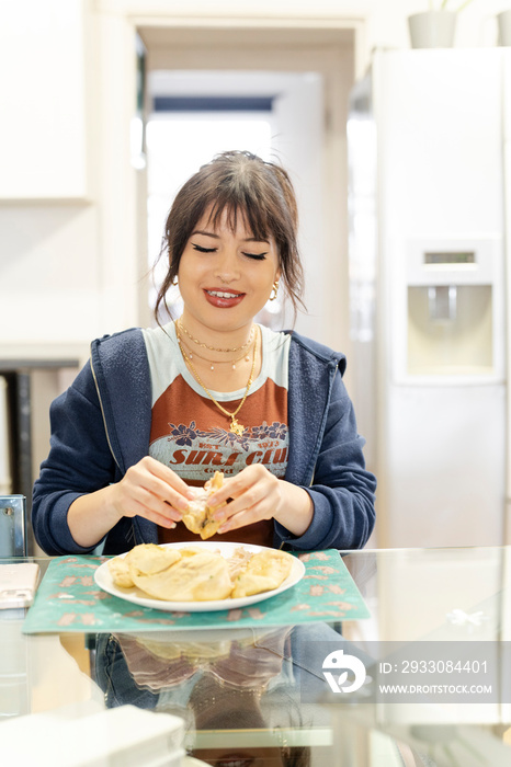 Young woman preparing food in kitchen