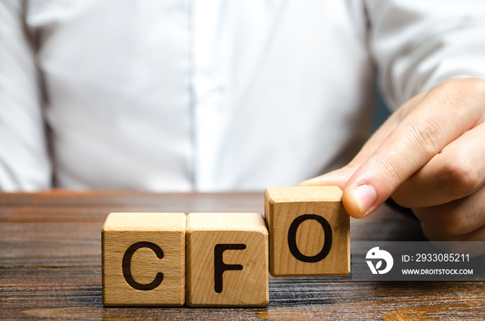 A man makes the word acronym abbreviation CFO. Chief Financial Officer. Financial management in business and company. Risk. Development and growth. Appointment to a new post, promotion.