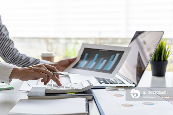 Businessman working in a private office, she is reviewing the company’s financial documents sent from the finance department before he takes it to a meeting with a business partner. Financial concept.