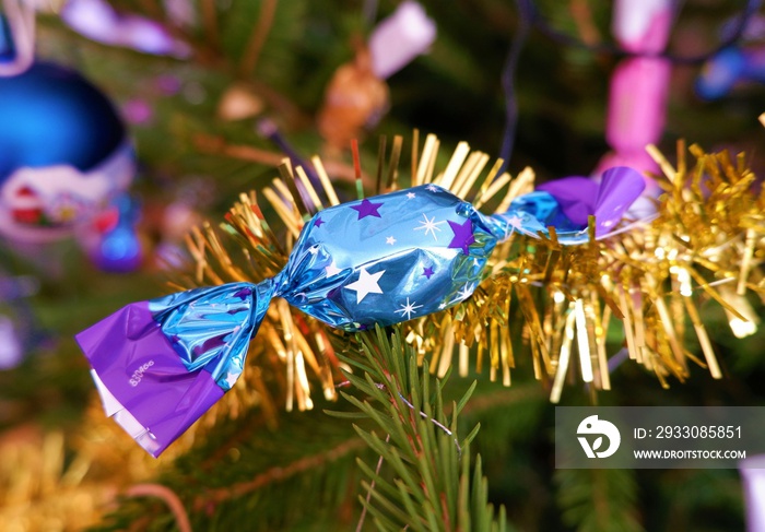 traditional Hungarian Christmas candy named szaloncukor in bright colorful packaging on the christmas tree