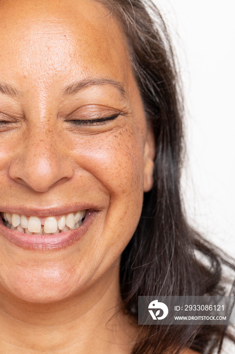 Close-up of smiling woman with eyes closed