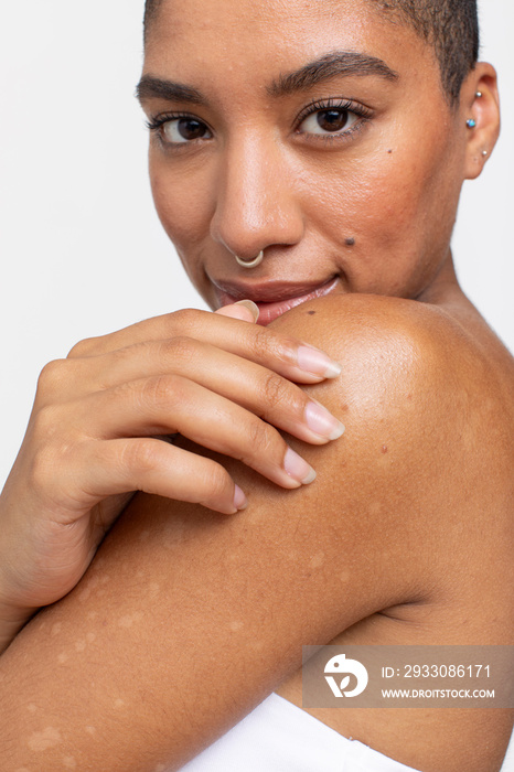 Studio portrait of smiling woman with nose ring