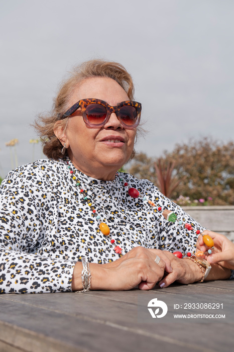 Portrait of elegant senior woman in sunglasses