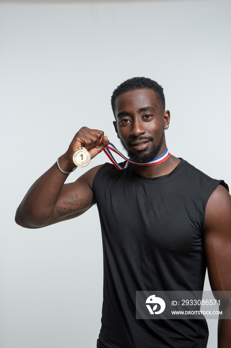 Man showing gold medal