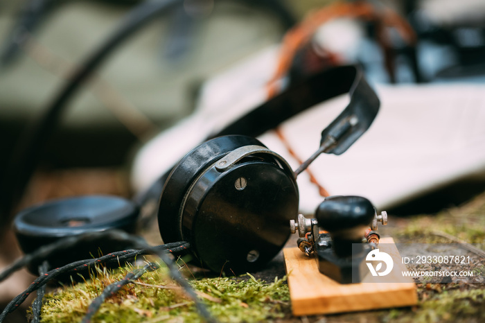 Russian Soviet Portable Radio Transceiver Used By USSR Red Army Signal Corps In World War Ii. Headphones And Telegraph Key Are On A Forest Stump.Russian Soviet Portable Radio Transceiver Used By USSR