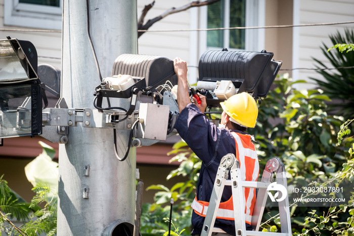 Electrician working at height with lamp