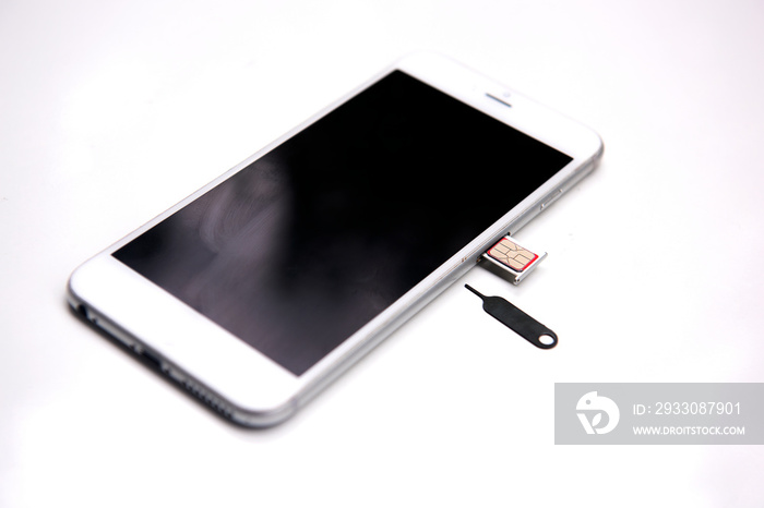 Side view Sim card tools, Small nano sim card card tray with smartphones Selective focus