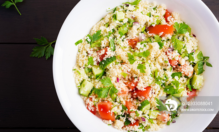 Traditional Lebanese Salad Tabbouleh. Couscous with parsley, tomato, cucumber, lemon and olive oil. Middle Eastern cuisine. Top view, copy space