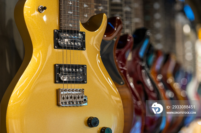 Row of electric guitars different color in a music instruments shop