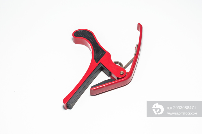 red capo for guitar isolated on white background