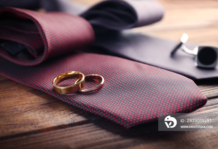 Wedding rings and cuff-links on ties, closeup