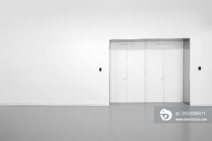 White walls and grey cement floors in the interior space