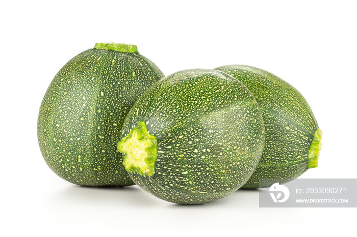 Three round zucchini fresh summer squash isolated on white background.