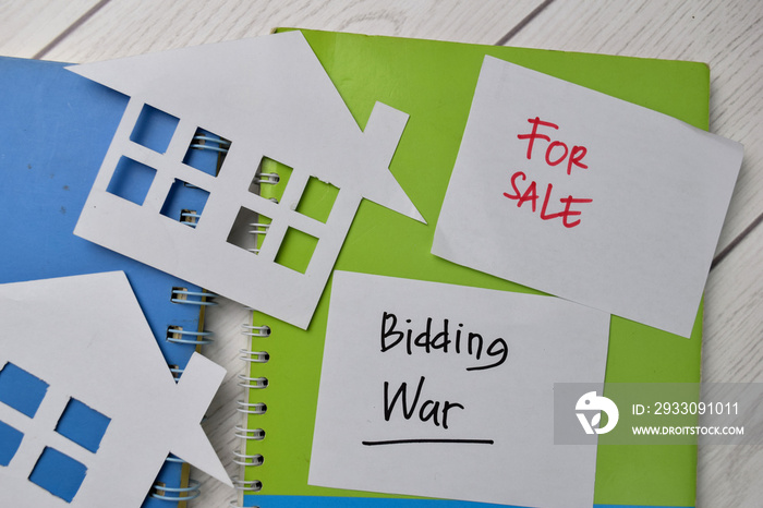 Bidding War and House For Sale write on sticky notes isolated on Office Desk