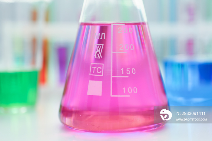 Chemical industry bulb with blue magenta pink liquid lab tubes stand on the table in the laboratory of liquid testing test development substances poisons additives stabilizers flavors house cleaning