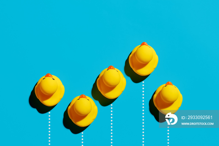 Rubber ducks racing in a competition. Business competition, struggle, achievement, speed or success