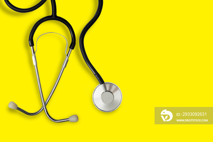 Top view blue stethoscope on yellow background. For check heart or health check up concept