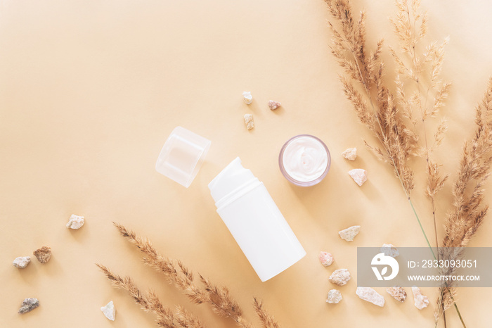 Organic natural cosmetics and dry pampas grass decoration on beige background. Top view, flat lay, mockup