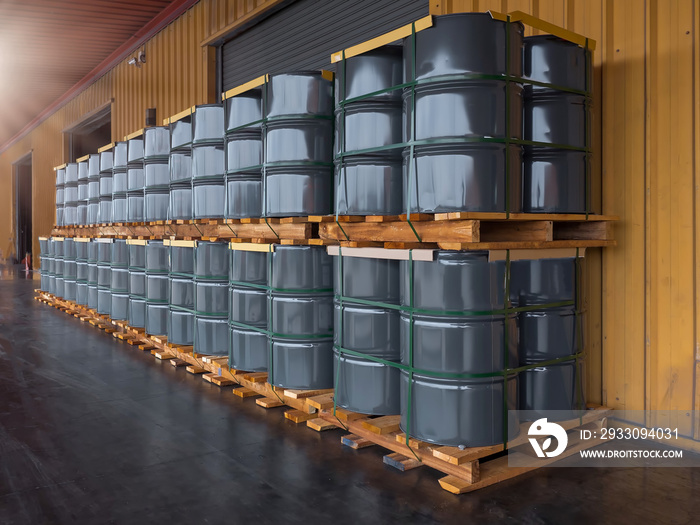 Gray oil drums on pallet stacking  in front of  industrail warehouse