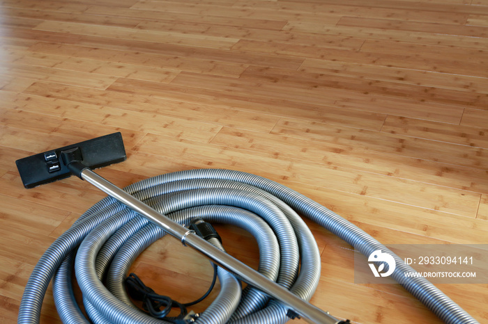 Beautiful bamboo hardwood floor with a central vacuum cleaner. Cleaning contest