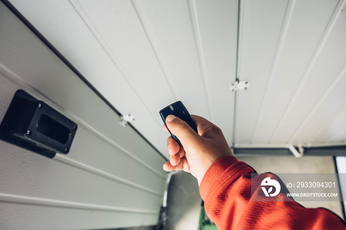 Garage door PVC. Hand use remote controller for closing and opening garage door