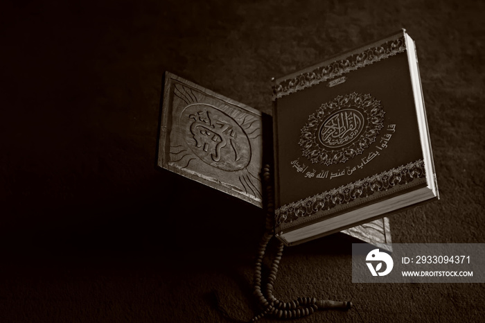 The Holy Alquran, holy book of Muslims and wooden prayer beads in a mosque