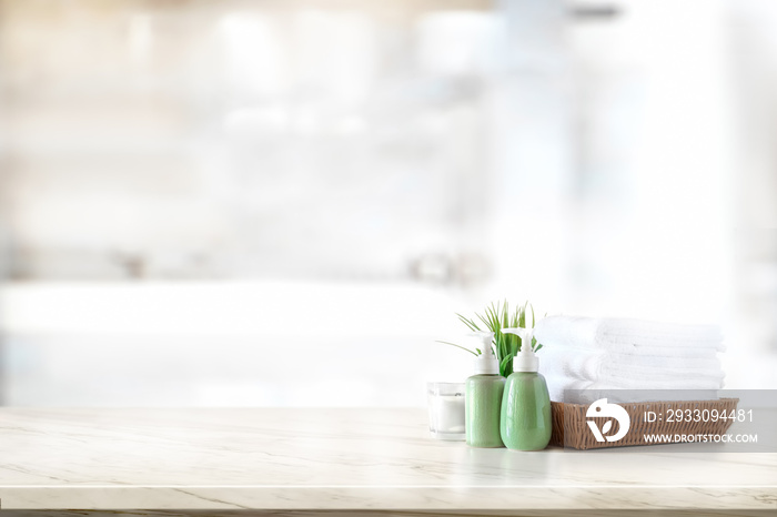 Ceramic shampoo, soap bottle and towels on counter over bathroom background. table top and copy space