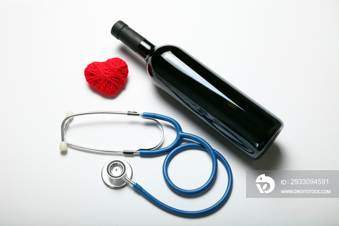 Heart care, red wine and stethoscope.