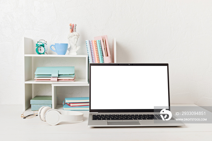 Empty laptop screen, desktop organizer with desk shelves and office supplies. Back to school, home office, begining of studies concept. Mockup, template