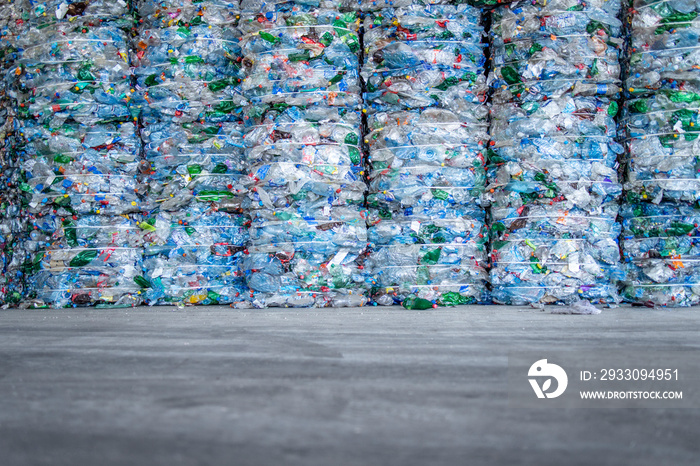 Large pile of plastic PET bottles compressed and ready for recycling. Separating and sorting garbage for modern recycle plant.