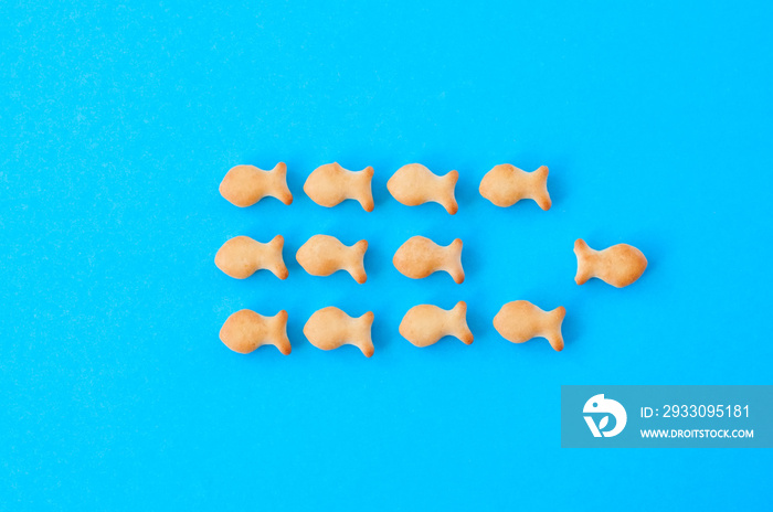 Crunchy fish crackers on a blue background.