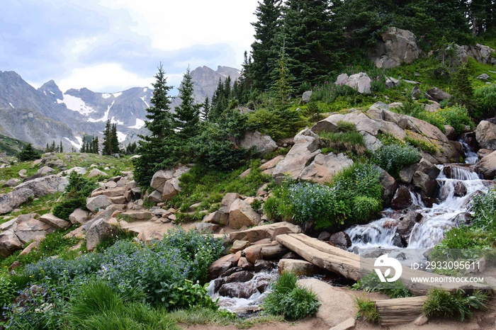 spectacular navajo, arapahoe, and shoshone peaks and a lovely mountain stream as seen in summer  on the hiking trail  up to isabelle lake in the indian peaks wilderness area, near nederland, colorado