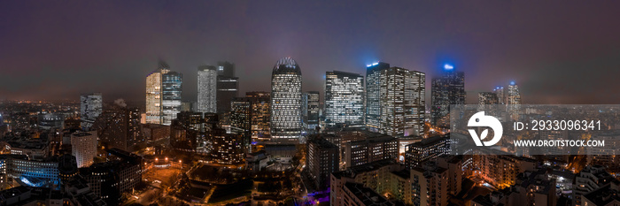 Panoramic aerial drone night shot of skyscrapers in Western Paris La Defense financial district in mist