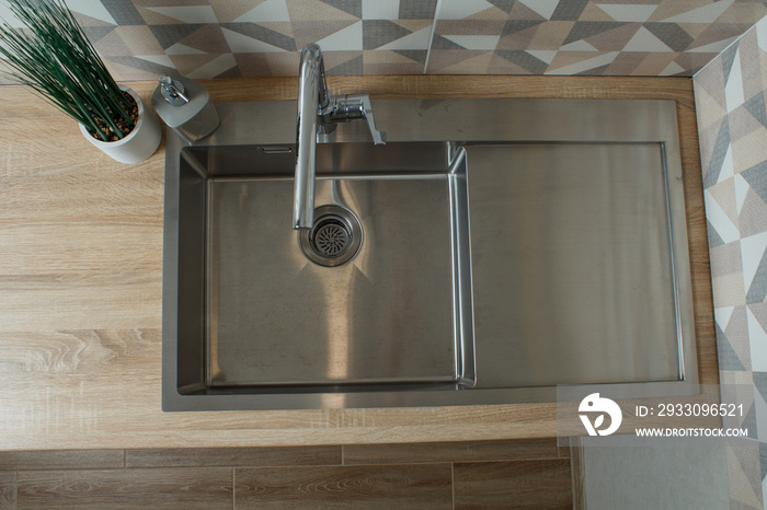 modern kitchen. light wood worktop with stainless steel sink and faucet. scandinavian style minimalism. top view