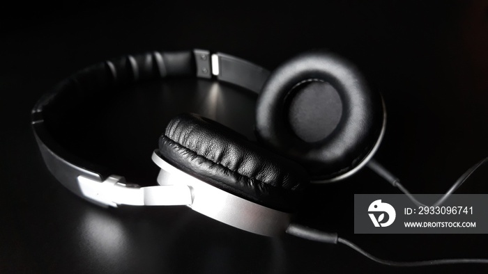 Black headphones isolated on a black background,close up