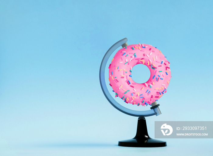 Creative Abstract composition with donut on a globe stand with pink background. Minimal food concept . Flat lay.