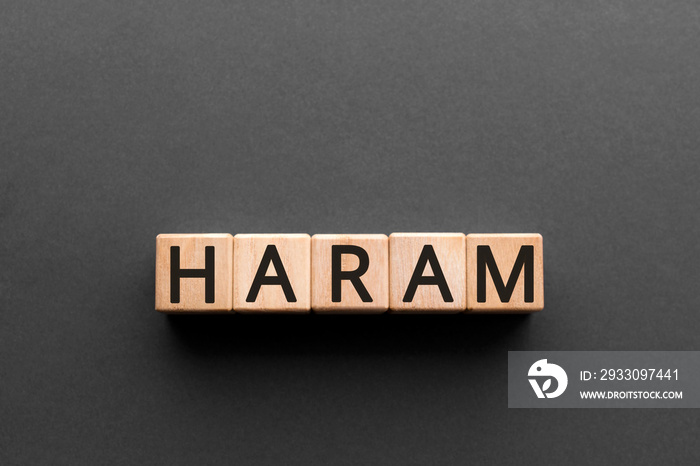 Haram - word from wooden blocks with letters, haram is an Arabic term meaning forbade concept, black background