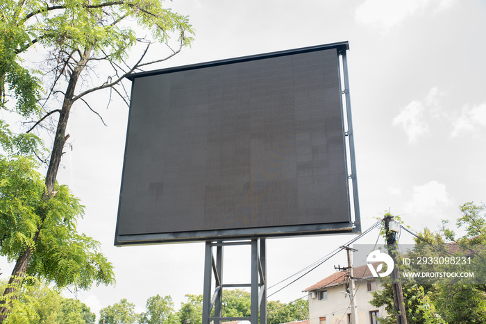 Big black led billboard commercial advertisement sign with electric panels and displays