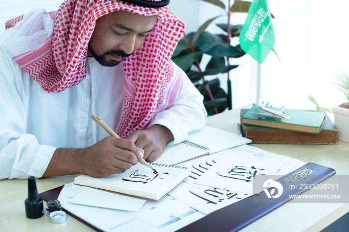 Arab men practicing writing Arabic with bamboo pens and ink on paper, Arabic letters mean the name of Muslim god  Allah , handwriting Khat