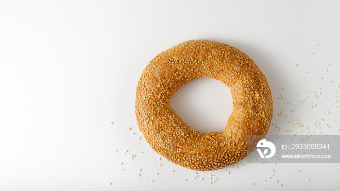 Traditional turkish simit bagel with sesame on light background with copy space