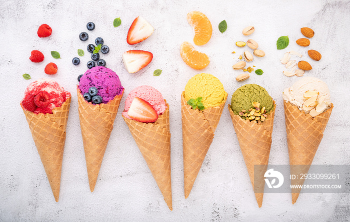 Various of ice cream flavor in cones blueberry ,pistachio ,almond ,orange and cherry setup on white stone background . Summer and Sweet menu concept.