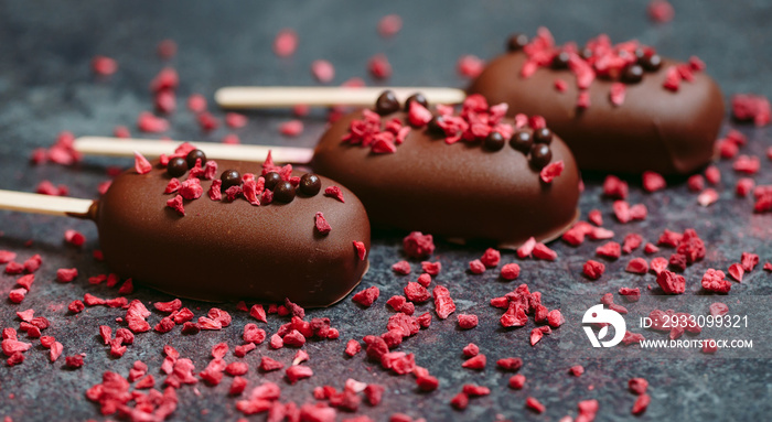 Chocolate bars are sprinkled with freeze-dried raspberries.