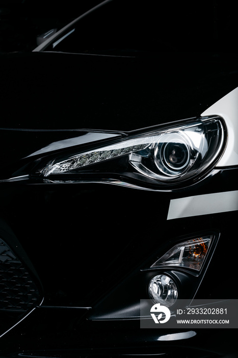 Car detailing series: Clean headlights of black sports car