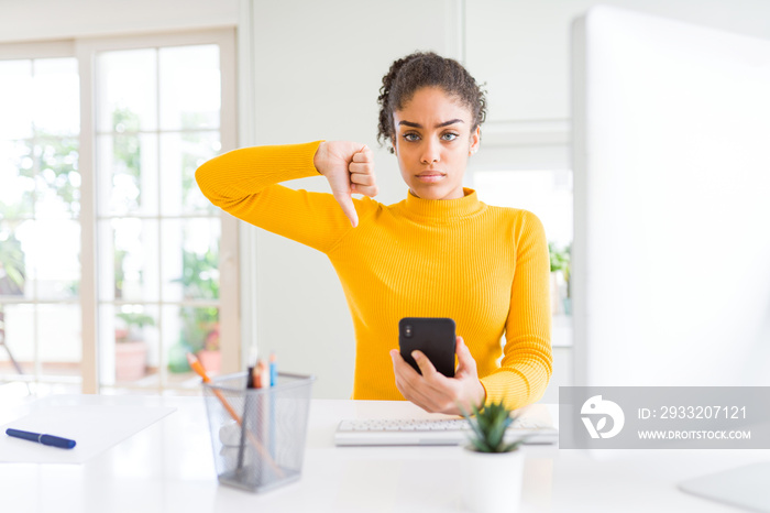 Young african american girl working using computer and smartphone with angry face, negative sign sho