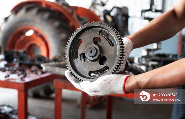 The mechanic captured the old spare parts of the tractor.