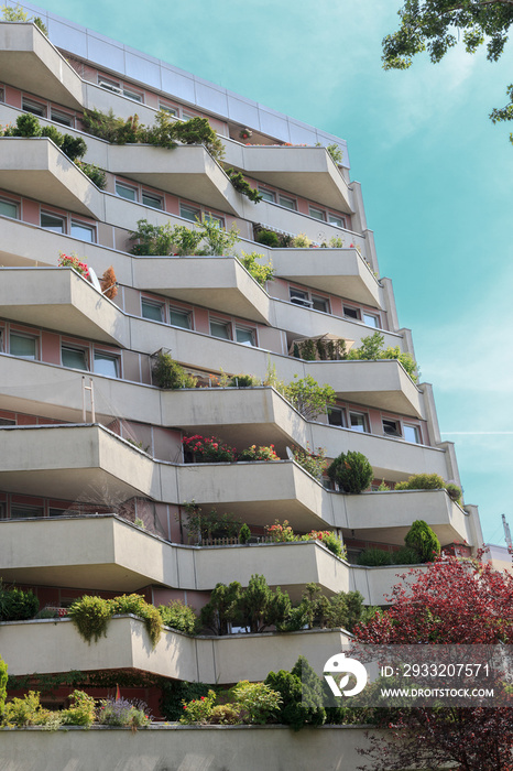 Summer landscape with apartment building, balcony with gardens